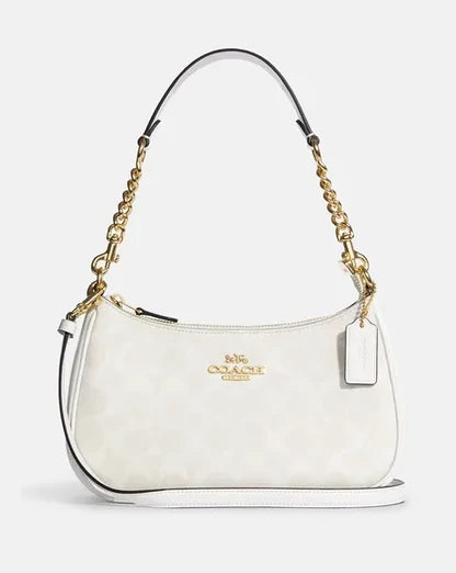White handbag with gold chain strap on a light gray background