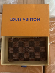 Louis Vuitton Zippy Coin Purse in brown Damier Ebene checkered coated canvas with gold-color zip-around closure