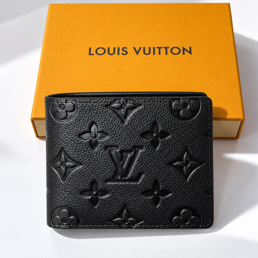 A black Louis Vuitton monogram embossed leather pouch placed in front of its signature orange box on a white background.