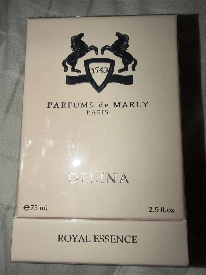 A 75ml box of Parfums de Marly Delina Royal Essence perfume, featuring a cream-colored packaging with black printed logo and text.